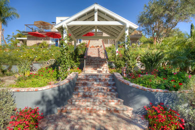 Large transitional backyard brick patio photo in Orange County with a gazebo