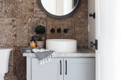 Example of an arts and crafts powder room design in Other