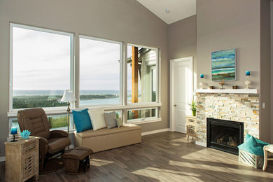 Example of a mid-sized trendy open concept bamboo floor and gray floor living room design in Portland with beige walls, a standard fireplace and a tile fireplace
