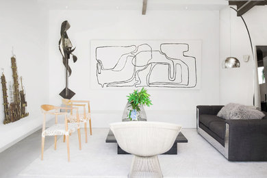 Beach style formal living room photo in Los Angeles with white walls