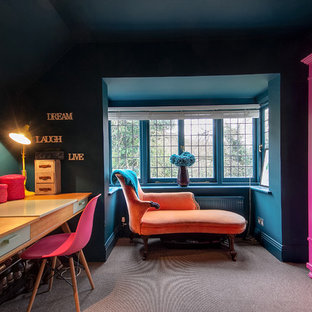 Photo of a bohemian home office and library in Surrey with blue walls, carpet, no fireplace, a freestanding desk and grey floors.