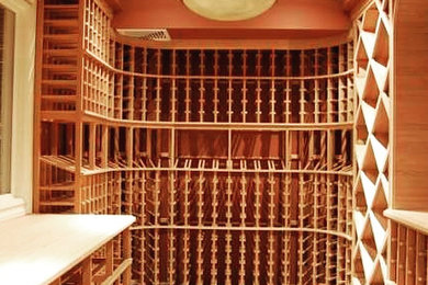 Tuscan terra-cotta tile and beige floor wine cellar photo in New York with diamond bins
