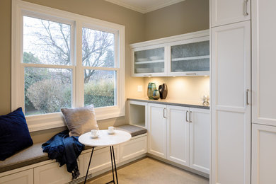 Inspiration for a small transitional u-shaped limestone floor and gray floor enclosed kitchen remodel in Seattle with an undermount sink, recessed-panel cabinets, white cabinets, quartz countertops, gray backsplash, ceramic backsplash, stainless steel appliances, no island and gray countertops