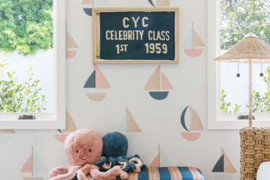 Inspiration for a mid-sized coastal guest medium tone wood floor and brown floor bedroom remodel in Orange County with white walls