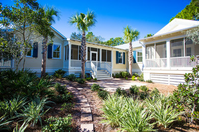 Small coastal yellow one-story concrete fiberboard gable roof idea in Miami