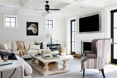 Large farmhouse open concept medium tone wood floor and brown floor living room photo in DC Metro with white walls, a standard fireplace, a stone fireplace and a wall-mounted tv