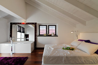 Photo of a large country master bedroom in Turin with white walls, dark hardwood floors and brown floor.