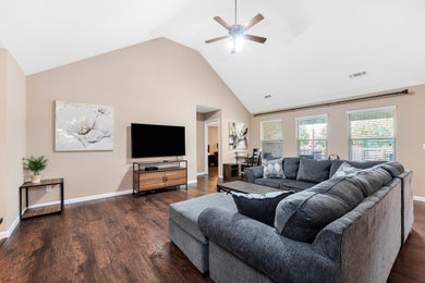 Inspiration for a mid-sized modern open concept laminate floor, brown floor and vaulted ceiling family room remodel in Los Angeles with beige walls