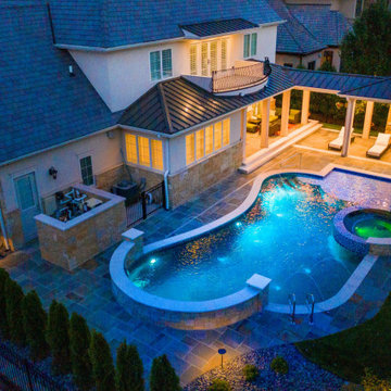 Naperville, IL freeform swimming pool with hot tub, large sunshelf, glass tile