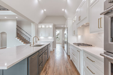Eat-in kitchen - transitional galley light wood floor and brown floor eat-in kitchen idea in Other with an undermount sink, shaker cabinets, white cabinets, quartzite countertops, white backsplash, quartz backsplash, stainless steel appliances, an island and white countertops
