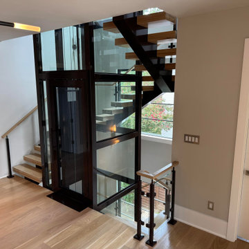 Project #136 | Modern Floating Staircase Encircling Glass Elevator