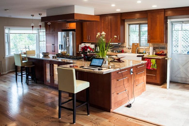 Inspiration for a large contemporary light wood floor eat-in kitchen remodel in DC Metro with a farmhouse sink, shaker cabinets, medium tone wood cabinets, granite countertops, beige backsplash, porcelain backsplash, stainless steel appliances and an island