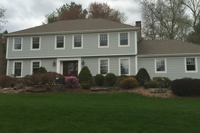 Inspiration for a large timeless gray two-story mixed siding exterior home remodel in New York