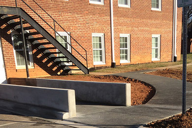 This is an example of a large traditional partial sun side yard concrete paver landscaping in Charlotte.