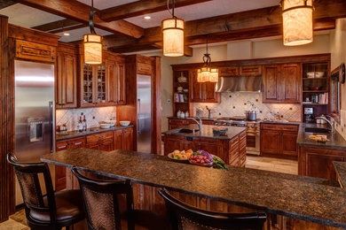 Inspiration for a large u-shaped porcelain tile eat-in kitchen remodel in Other with an undermount sink, raised-panel cabinets, medium tone wood cabinets, granite countertops, beige backsplash, ceramic backsplash, stainless steel appliances and two islands