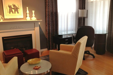 Small transitional open concept light wood floor living room photo in Other with gray walls, a standard fireplace, a wood fireplace surround and a tv stand
