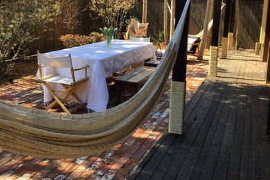 Patio - small traditional backyard brick patio idea in Boston with a roof extension