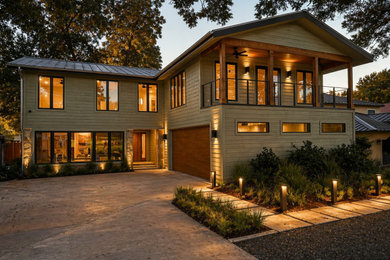 Inspiration for a mid-sized transitional green two-story wood and clapboard exterior home remodel in Austin with a metal roof and a gray roof