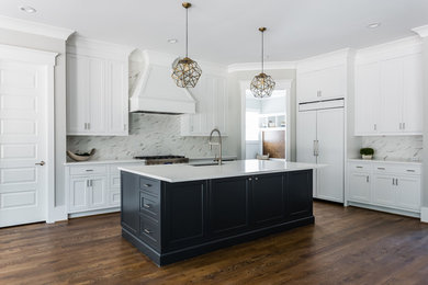 Photo of an expansive transitional l-shaped kitchen in Raleigh with an undermount sink, beaded inset cabinets, white cabinets, quartz benchtops, stainless steel appliances, dark hardwood floors, with island, brown floor and white benchtop.