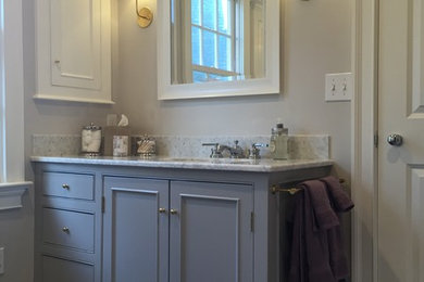 Photo of a mid-sized traditional bathroom in New York with beaded inset cabinets, grey cabinets, multi-coloured tile and a drop-in sink.