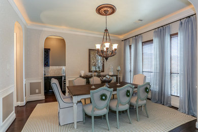 Example of a large classic dark wood floor enclosed dining room design in Houston with gray walls