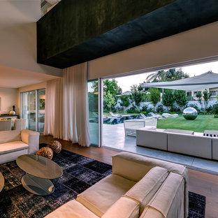 Inspiration for a large modern formal open plan living room in Frankfurt with brown walls, terracotta flooring, a wood burning stove, a metal fireplace surround, a freestanding tv and beige floors.