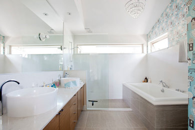 Inspiration for a mid-sized eclectic master brown tile drop-in bathtub remodel in Vancouver with blue walls