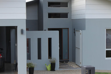 This is an example of a mid-sized modern entryway in Cairns.