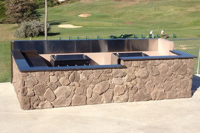 Example of a large beach style backyard kidney-shaped natural pool design in Hawaii with a bbq area