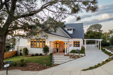 Mid-sized farmhouse white two-story mixed siding and board and batten exterior home photo in San Diego with a metal roof and a gray roof