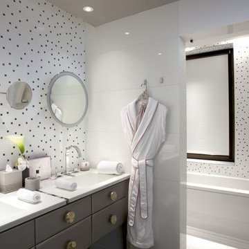 Contemporary white bathroom with grey cabinets