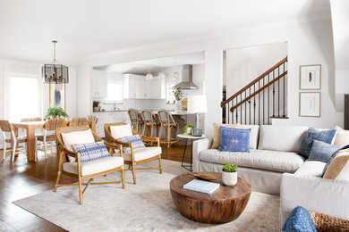 Living room - mid-sized transitional open concept medium tone wood floor and brown floor living room idea in Dallas with white walls and a wall-mounted tv