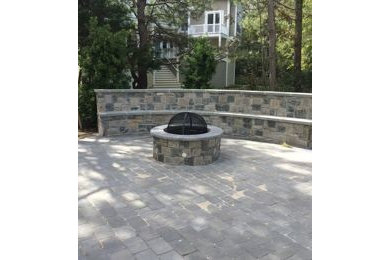Inspiration for a huge contemporary partial sun backyard stone landscaping in Other for fall.