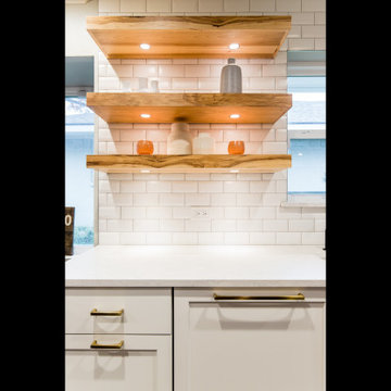 Open Wood Shelves with undermount lighting paired with a white subway tile and w