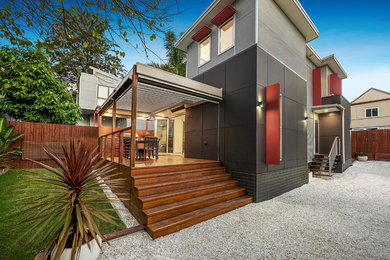 Mid-sized contemporary two-storey grey exterior in Sydney with a flat roof.