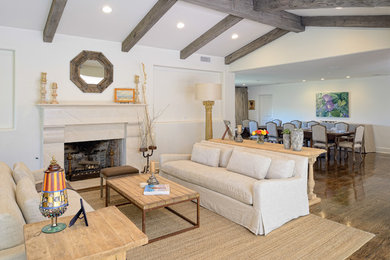 This is an example of a country open concept living room in Austin with a standard fireplace.
