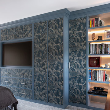 Bespoke fitted wardrobes with wallpapered panels