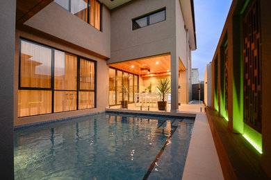 This is an example of a small modern backyard rectangular pool in Perth.