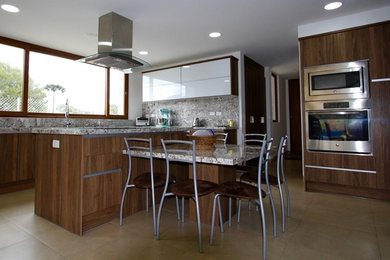 Kitchen - mid-sized contemporary l-shaped marble floor kitchen idea in Other with a double-bowl sink, flat-panel cabinets, medium tone wood cabinets, granite countertops, stainless steel appliances and an island