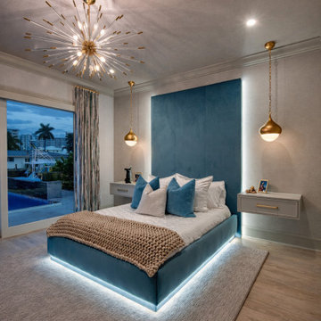 Blue Bedroom with Sculptural Lighting and Backlit Upholstered Headboard