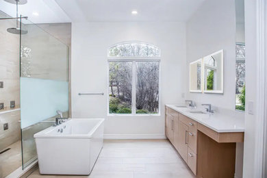 Example of a large minimalist beige tile and ceramic tile ceramic tile, beige floor and double-sink bathroom design in St Louis with flat-panel cabinets, light wood cabinets, a bidet, white walls, an undermount sink, quartz countertops, white countertops and a built-in vanity