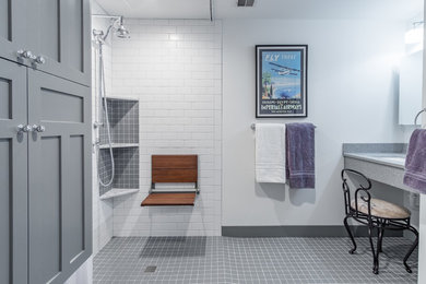 This is an example of a small country master bathroom in Kansas City with shaker cabinets, grey cabinets, a wall-mount toilet, white tile, subway tile, white walls, ceramic floors, onyx benchtops, grey floor, a shower curtain, a curbless shower and an integrated sink.