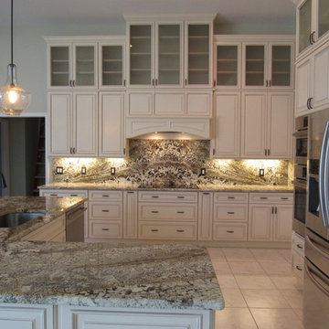 Full height back splash ivory kitchen.