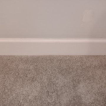 Residential carpet installation with 5 1/4" base molding and transition strips