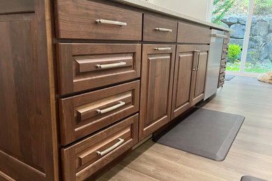 Eat-in kitchen - large transitional l-shaped vinyl floor eat-in kitchen idea in Seattle with an undermount sink, quartz countertops, gray backsplash, porcelain backsplash, stainless steel appliances, an island, white countertops, raised-panel cabinets and medium tone wood cabinets