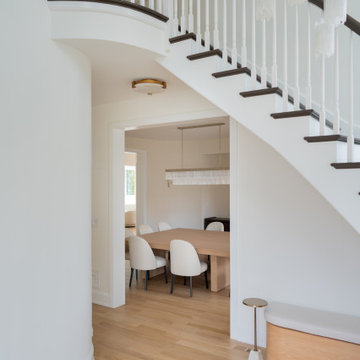 Elegant Two-Story Entry with Curved Staircase and Natural Light