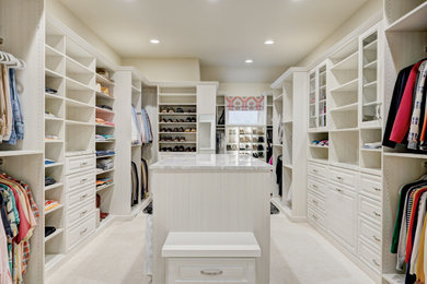 Large transitional gender-neutral dressing room in Oklahoma City with raised-panel cabinets, light wood cabinets, carpet and beige floor.