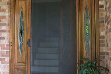 This is an example of a small traditional front door in Other with a single front door and a medium wood front door.