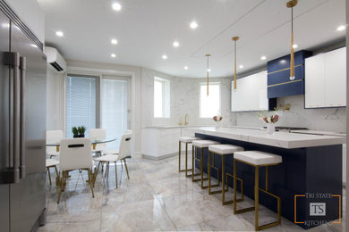 Inspiration for a large contemporary l-shaped eat-in kitchen in New York with an undermount sink, flat-panel cabinets, white cabinets, quartzite benchtops, white splashback, stone slab splashback, stainless steel appliances, ceramic floors, with island, multi-coloured floor and white benchtop.