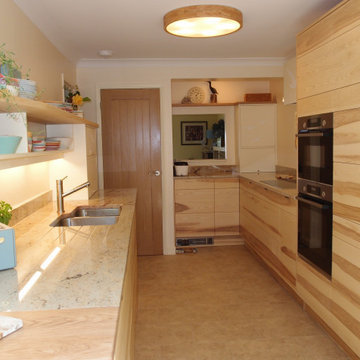 Galley kitchen in Ash with carvings